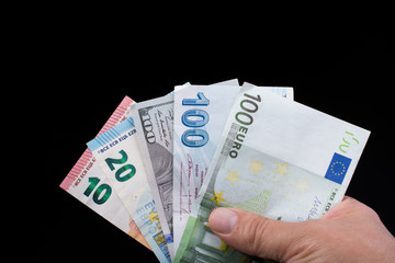 Hand holding American dollar  isolated on black background