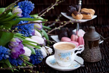 Easter eggs in a basket on a background of spring flowers