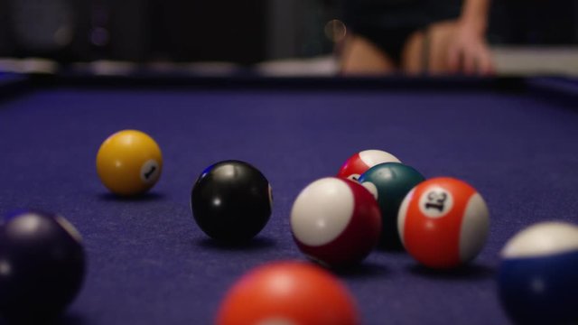 Woman in lingerie plays pool