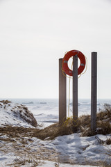 Fototapeta premium Orange buoy against winter sky
