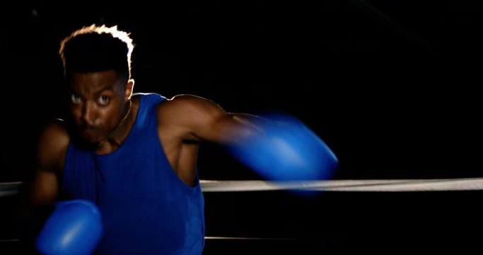 A boxer practices punches and hooks while shadowboxing