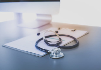 Medical equipment: blue stethoscope and tablet on white background. Medical equipment