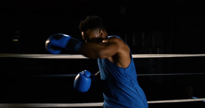 Male boxer shadowboxes in ring, slow motion