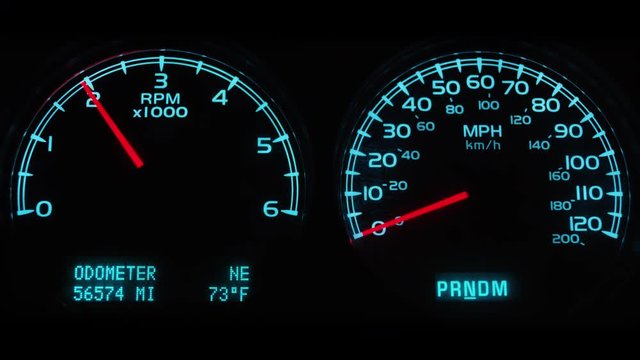 Close up, tachometer jumps on car dash