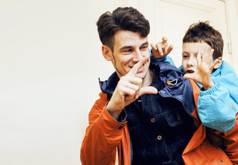young handsome father with his son fooling around at home, lifes