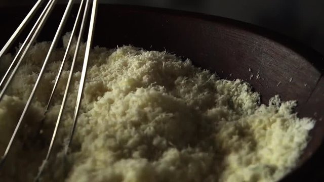 Wire whisk mixes ingredients in mixing bowl