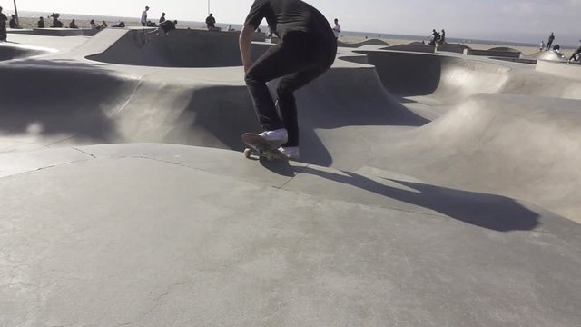 Teenage boy skates in skate park