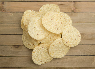 Round Tortilla Corn Chips on a Wooden Table