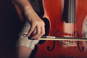 Close up of hands playing a cello © lonnyinco