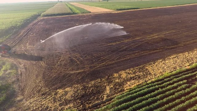 Aerial footage of land irrigation with typhon sprinkler. Preparation for sowing.