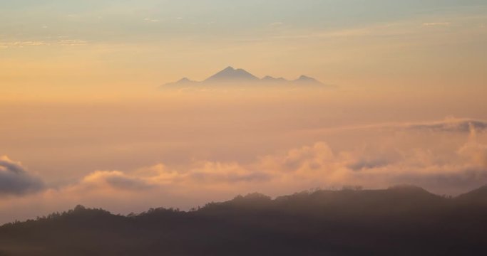 Timelapse of Mount Agung an Active Volcano In Bali, Indonesia with clouds and sun moving gently around it