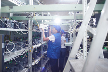 Mining. A man working on a farm for the extraction of crypto currencies. Bitcoin business