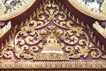  Gold gable temple stucco roof with buddha Sheltered by Naga Hood patterns on background