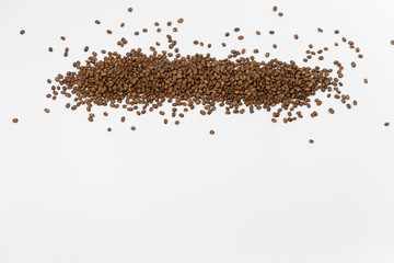 Fototapeta premium Coffee Beans spilled on white backdrop