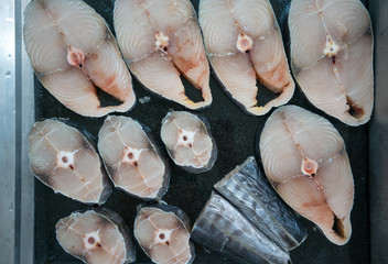 some slices of fresh raw fish on a black background