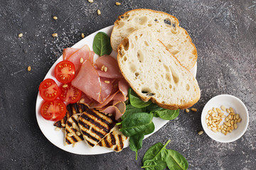 Halloumi cheese with bruschetta, tomatoes, prosciutto, honey, pine nuts. Healthy snack. Top View