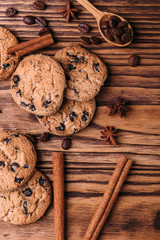 oatmeal cookies with chocolate on a wooden background