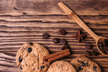 oatmeal cookies with chocolate on a wooden background