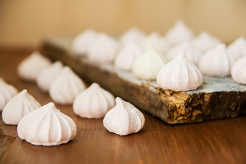 lots of little meringues on dark wooden background
