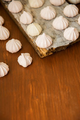 lots of little meringues on dark wooden background