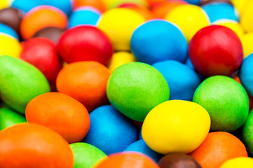 Sweet round multi colored candies. Close up. Abstract and food background.