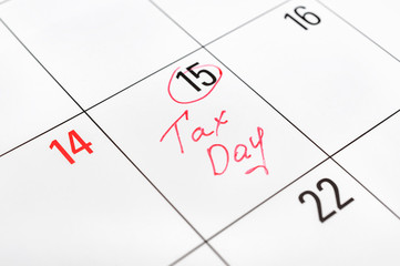 Tax day written on the calendar and circled 15th day by marker. Tax pay Deadline concept.