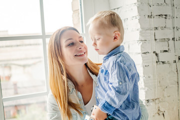 Happy Mother and her Little Son Portrait. Pretty  Mom and Child Boy Embracing and Having Fun