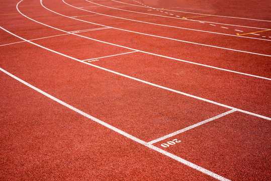 red running track on athletic stadium background texture