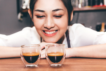 Barista holding coffee in coffee shop
