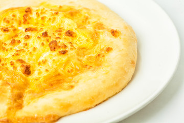 Traditional flatbread khachapuri or hachapuri on white plate