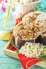 Colomba - italian easter dove cake on old rustic cyan wooden board. Selective focus, free text space.