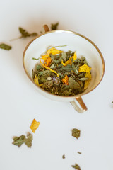 Cup with herbal tea leaves