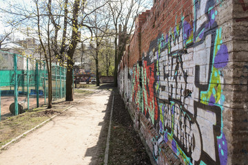 A path along the wall with graffiti.