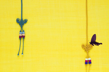 Korean traditional knot & butterfly background of yellow ramie fabric. 