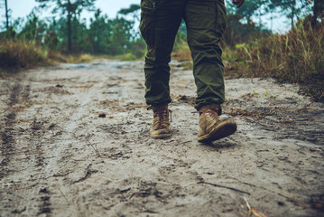 Asian men travel photograph nature. Travel relax. Walk on the path. Nature Study in the Jungle. Thailand
