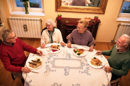 Senior People Enjoy And Smiling While Eating Dinner At Nursing Home