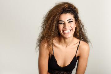 Fototapeta premium Young happy woman with curly hairstyle smiling