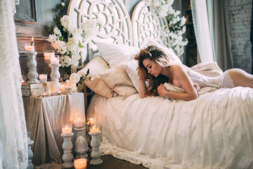 Beautiful boudoir morning of the bride on the bed. - obrazy, fototapety, plakaty