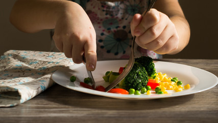 Broccoli with vegetables on a white plate. Vegetarianism. Healthy food.