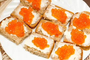 Dishes from sliced bread and red caviar