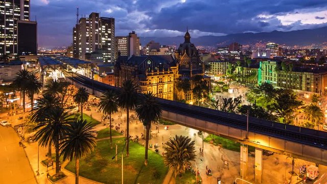 Medellin, Colombia, time lapse view of downtown buildings and Plaza Botero square at dusk. Dolly left to right.