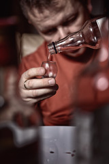 man pours vodka into the glass