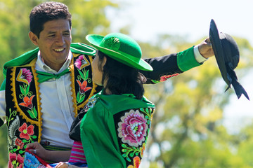Peruvian couple dancing Huayno, a traditional musical genre typical of the Andean region of Peru, Bolivia, northern Argentina and northern Chile - obrazy, fototapety, plakaty