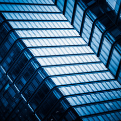 Fototapeta na wymiar detail of modern glass building,blue toned.