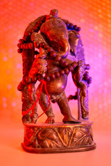 Hindu God - Lord Ganesha with rudraksha rosary in a colorful light. Colorful photo of deity Ganesha whit blured background.