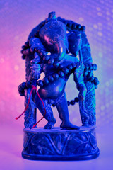 Hindu God - Lord Ganesha with rudraksha rosary in a colorful light. Colorful photo of deity Ganesha whit blured background.