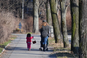 Young mother and her daughter walking in a park in Berlin-Germany 