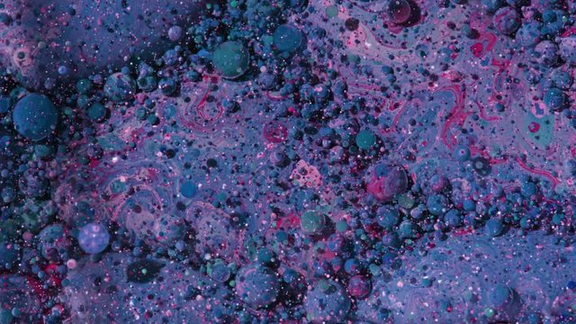 Top view Bright Collors Bubbles Slow Motion Oil Ink is fantastic structure of colorful chaotic motion bubbles stock video is a beautiful, unique, organic 4K clip.