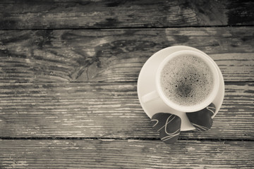 White cup of coffee on a natural old wooden background with biscuits. Selective focus. With copy space