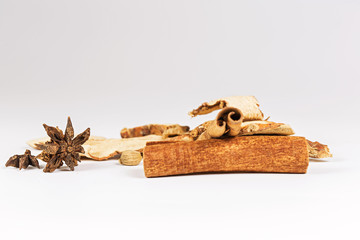 Spices for stewed beef on white background.